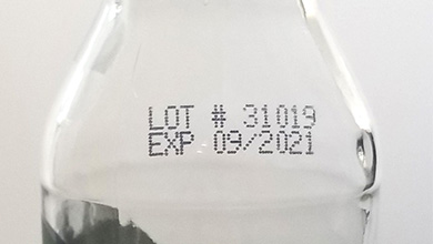 Glass bottle with black ink date printing code